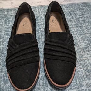 Clarks black suede slip-on shoes.